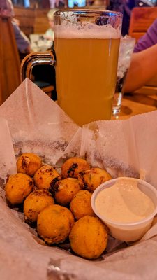 Rattlesnake bites with jalapeños and jack cheese,  served with Ranch or Cajun sauce and the drink is Mango Cart. Very good!