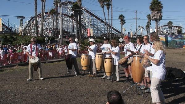 Jim conducts a drum circle to start 15,000 runners at a benefit race in Santa Cruz, CA.