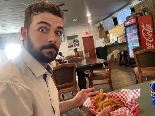 My husband eating wings and fries catfish