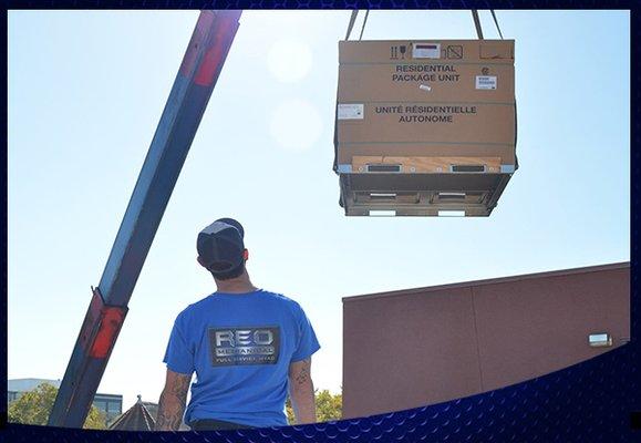 Curtis lifting HVAC unit on top of building downtown Kst. 2017