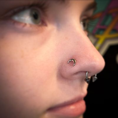 Gold nose piercing body jewelry studio