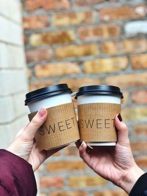 Hot chocolate, one with whole milk, one with oat milk