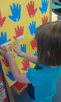 The students "check in" every day by matching their name with their photo.