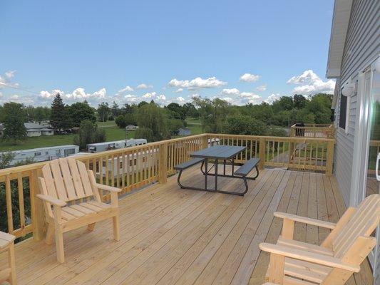 Picnic table, gas grill and Adirondack chairs on every cottage/home deck