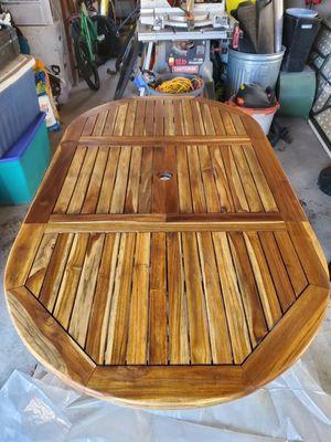 Freshly oiled teak table after power washing and sanding.