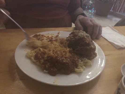 A giant meatball and homemade pasta.