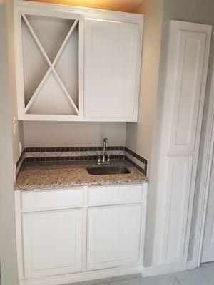 Small wet bar with wine bottle rack.