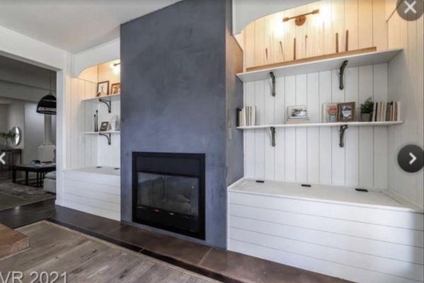 Fireplace in family room with built in shelves on either sides. Good for family photos or even your book collection!