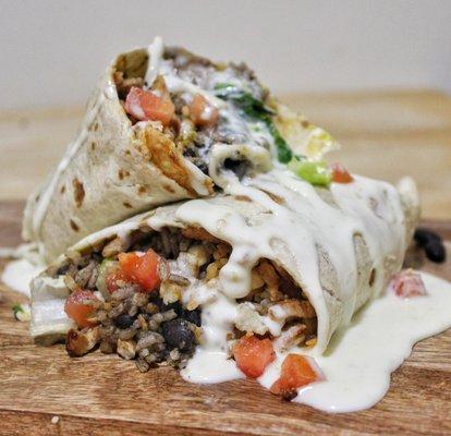 Burrito: Flour tortilla, choice of meat, rice, black beans, shredded cheese, lettuce, tomato and melted cheese.