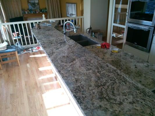 This beautiful granite island is over 14 feet long and includes a raised breakfast bar.