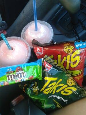 Two slurpees, Takis nitro and Takis Zombie, and a rice krispie with m&m's