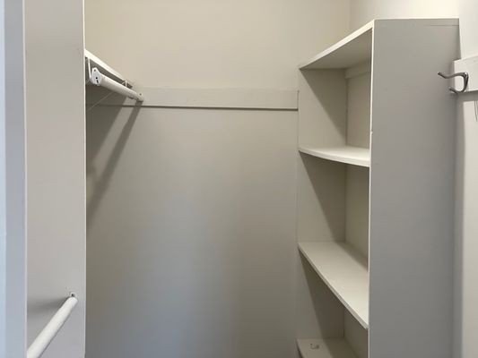 Large walk-in closets with overhead lighting.