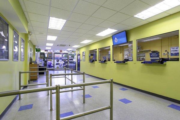 Customer waiting area and teller windows inside PAYOMATIC store located at 11 East Gunhill Road Bronx, NY 10467