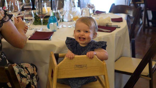 A cute baby at a wedding reception.