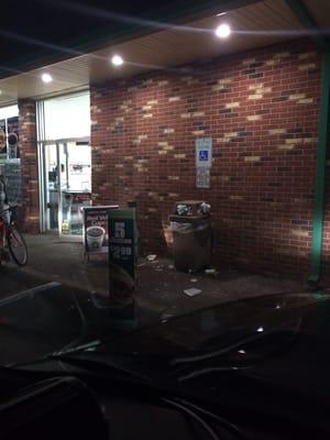 Gross overflowing garbage cans at entrance.