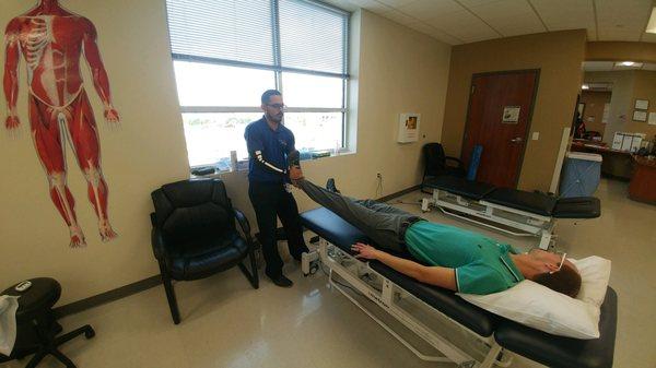 Physical therapist performing manual therapy techniques.