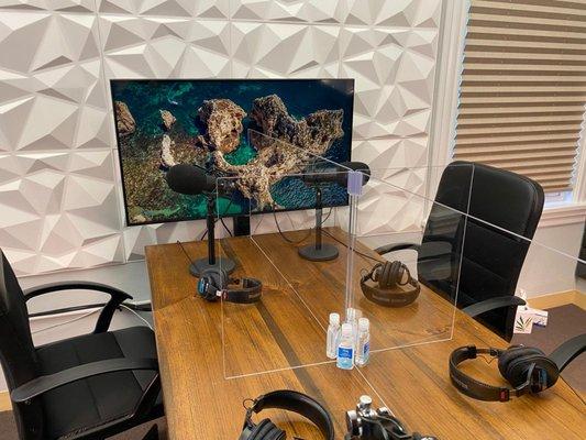 Our studio is fully sound-proofed with plexiglass dividers between podcasters and hand sanitizer at each podcasting station.