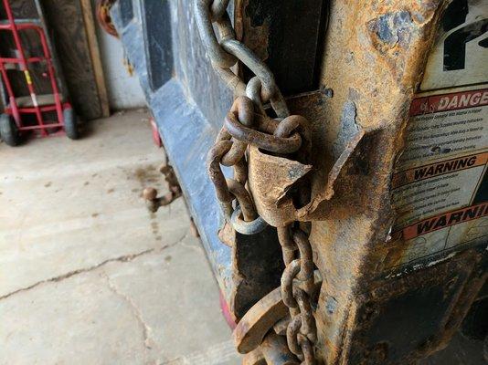 Torn out gate chain hooks on both sides of the truck.