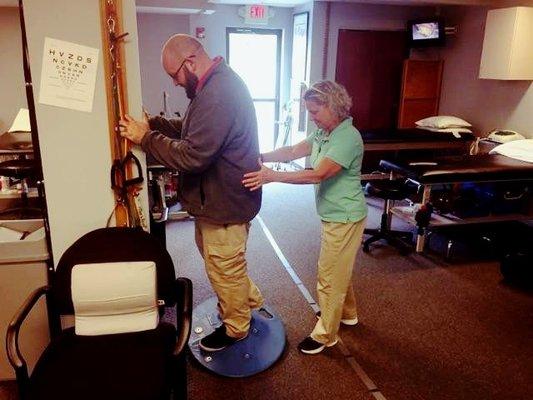 Therapist working with patient on exercises.