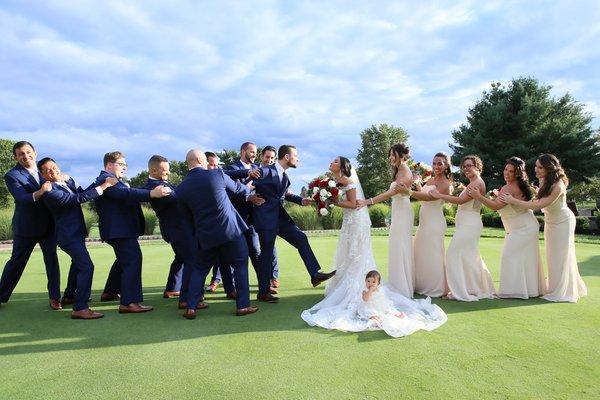 Bridal party having fun with newlyweds