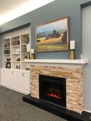 Cozy living room with fireplace and areas to relax and have conversations.