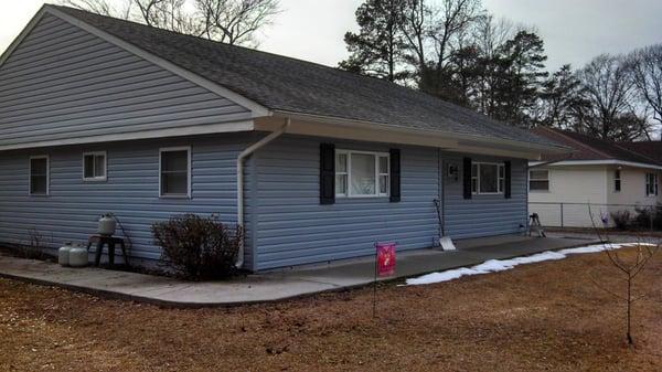 Siding over cinder block home.