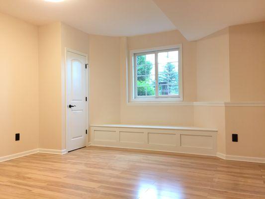 Novi finished basement bedroom complete with built-in bench seating, egress exit & Pergo flooring throughout.