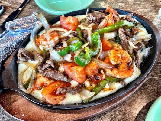 Queso fundigo with veggies, steak, and shrimp