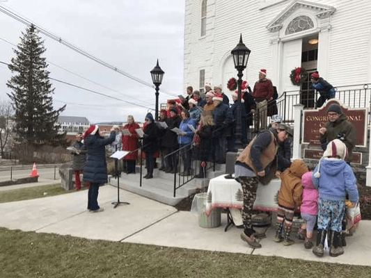 Our Chancel Choir singing on the front steps at Christmas time.