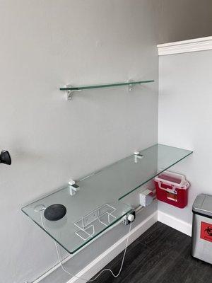 Bottom shelf was a custom design done by Tayloe Glass. This shelf is used as a tattoo station for a right handed artist.