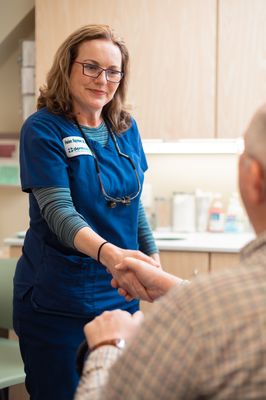 Dr Raynham meeting with a patient