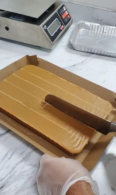 Cutting some fresh peanut butter fudge!  Yum!!