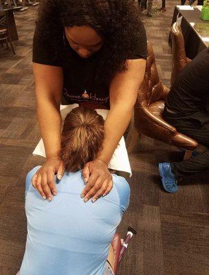 Chair massage at a Xsport Fitness gym pop up.