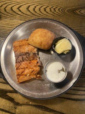 A delicious dinner of salmon with a fresh roll.