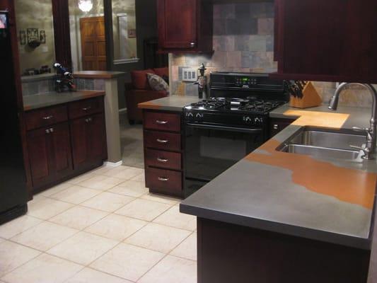 Concrete countertop with custom flowing pattern crossing the kitchen