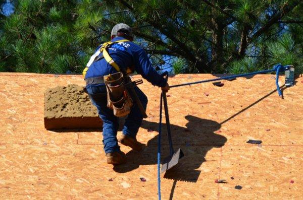 Capstone Roofing employees removing the shingles to the decking.