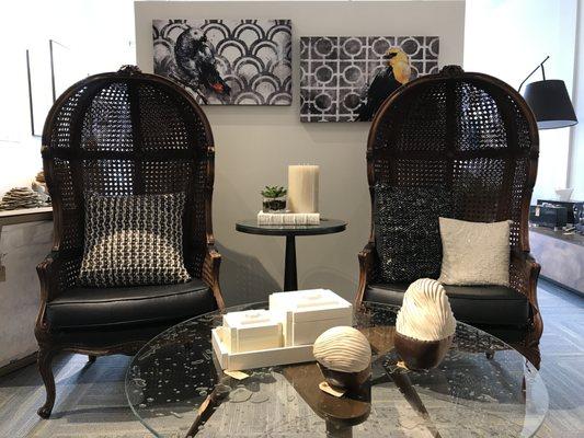 Antique cane chairs paired with a contemporary glass cocktail table