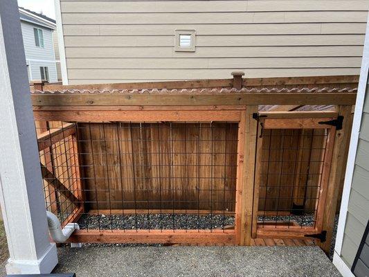 Full side view of off-the-porch dog run.  Keeps dogs completely dry by going from covered porch to covered potty area.