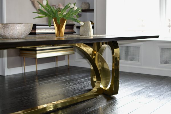 Ebonized walnut with sculpted brass base dining table