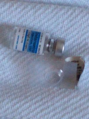 Vial on the bed, patient was on the chair, syringe on floor. Wrapper of a pill dispensed as well.