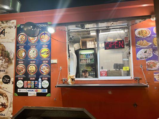 walk-up view of food truck, peep the smiling, friendly owner working the truck! also peep the drink options in the fridge behind him ;)