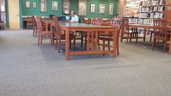 Upstairs, tables for setting up laptops (outlets on the floor) & for studying.