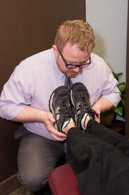 Dr. Yates performing a leg length inequality test using the NUCCA upper cervical technique.