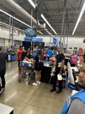 Walmart closes at 11 PM It's 10:49 PM and there are no registers open. There's a line from self ck out to the frozen area it's ridiculous.