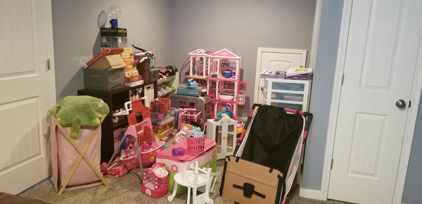 Very cluttered toy room, turned into kids homework area.