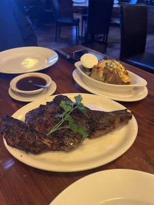 Incredible rib eye and loaded baked potato.