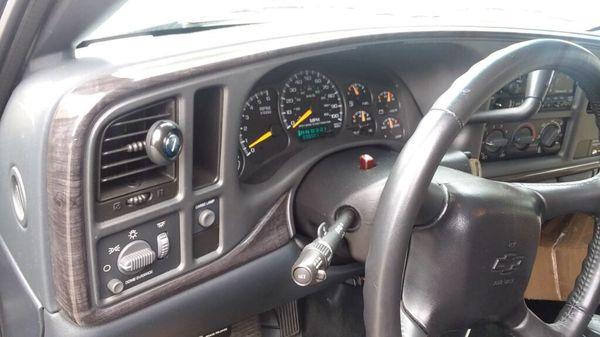 Denali cluster trim piece on Silverado. (Smoked grey wood grain)