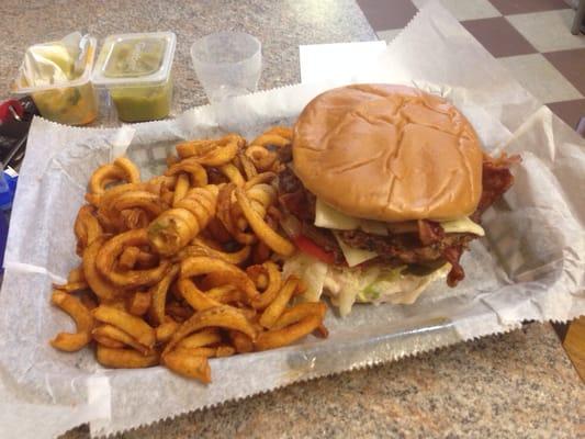 Double spicy cheeseburger with curly fries.