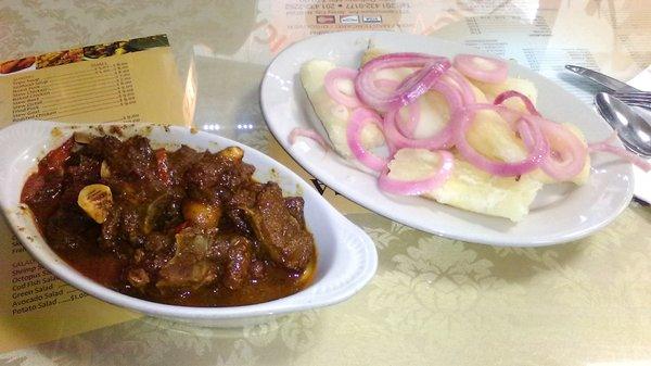 Flavorful Goat Stew with Yuca and Onions. Large Portions and Affordable.