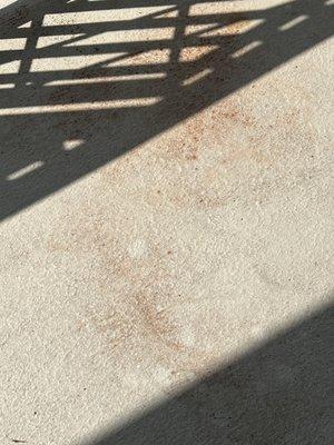 Red sediment on balcony floor